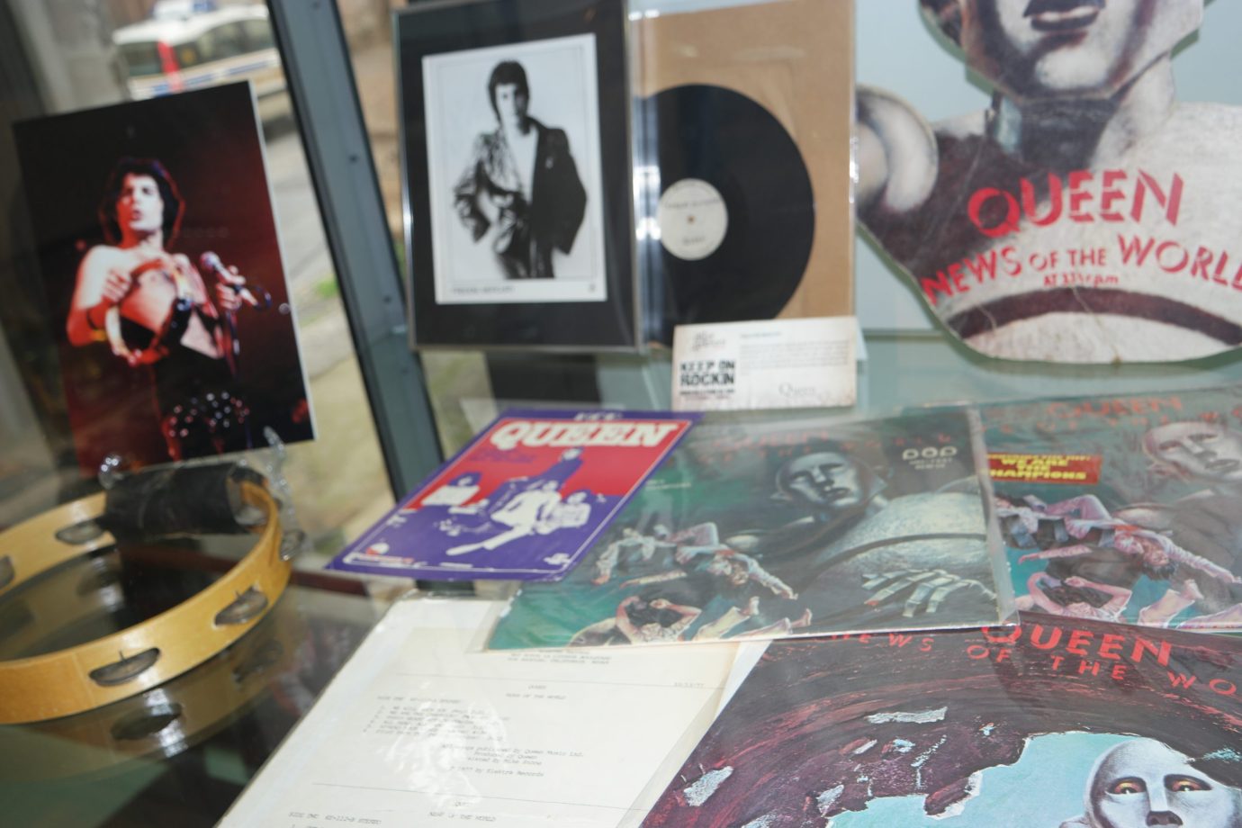 News of the World display case with the die-cut robot standee, promotional photos, tambourine and world pressings