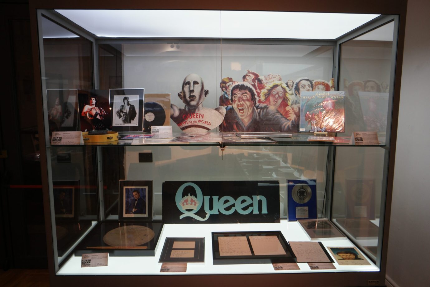 Wide view of the News of the World exhibition case, robot standee and surrounding memorabilia